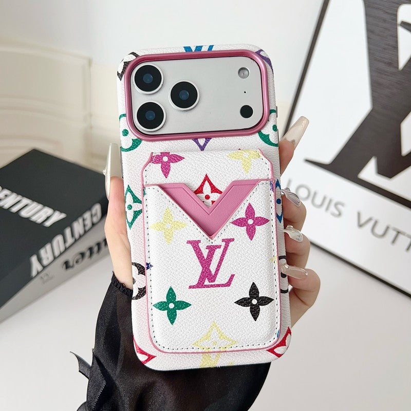 Phone case with colorful pattern held by a hand, with 'Louis Vuitton' branding in the background.
