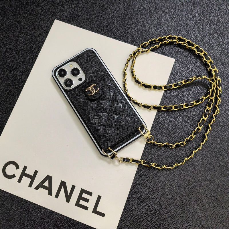 Black quilted phone case with gold chain on a Chanel branded paper